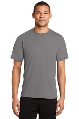 A man wearing a grey Port & Company Performance Blend T-Shirt, standing against a neutral background.