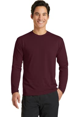 A long sleeve performance blend tee in maroon worn by a smiling male model, featuring branding.