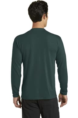 A man wearing a long sleeve performance blend tee in dark green, viewed from the back, with a logo present.