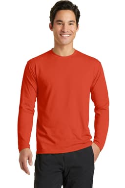 A man wearing a long sleeve performance blend tee in bright red. The shirt has a logo on it.