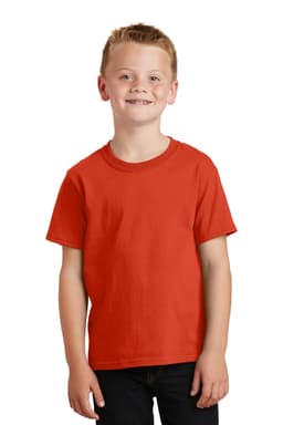 A youth wearing a bright red cotton t-shirt, standing with a smile and casual jeans. The shirt has a logo.