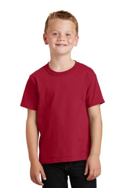 A young boy smiles while wearing a red youth t-shirt. The shirt has short sleeves and a simple design.