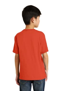 A youth in a red T-shirt is seen from the back, wearing jeans and standing against a plain background.
