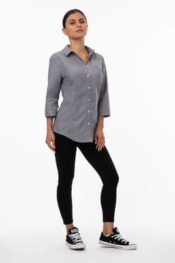 A grey and white striped classic shirt with long sleeves, paired with black leggings and casual sneakers.