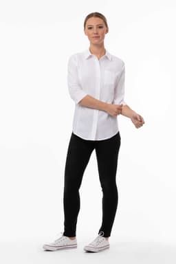 A white women's classic shirt with a collar and rolled sleeves, paired with black leggings and white sneakers.