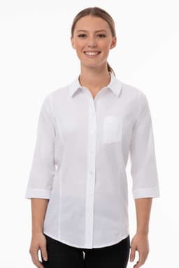 A white women's classic shirt with a collar and three-quarter sleeves, featuring a pocket and a logo.