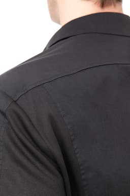 A black men's shirt featuring a collared design and smooth fabric, with a visible logo on the back.