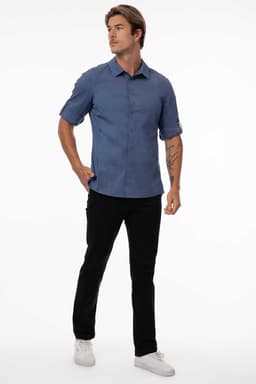 A black men's shirt with short sleeves and a fitted design, paired with black pants and white shoes.