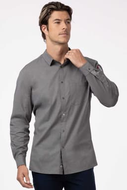A grey men's shirt with long sleeves and a button-up front, featuring a pocket and a logo on the sleeve.
