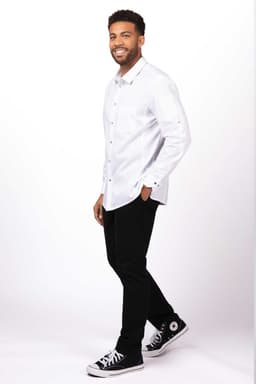 A men's black shirt with a classic collar and buttons, worn with black trousers and sneakers.