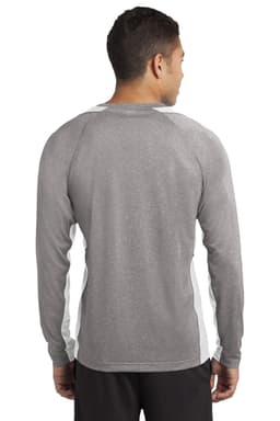 A man wearing a grey long sleeve t-shirt with white colourblock accents, featuring a logo on the back.