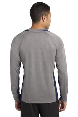 A man is wearing a long sleeve heather grey tee with navy colourblock accents on the sides and shoulders.
