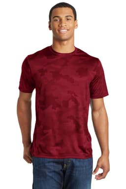 A man wearing a maroon Sport-Tek CamoHex T-Shirt with a camouflage pattern and a logo on the front.