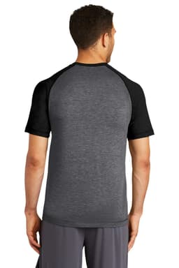 A black and grey Sport-Tek PosiCharge tri-blend wicking raglan tee, displayed from the back. The shirt features short sleeves and a logo.