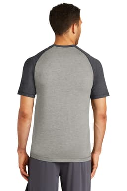A grey t-shirt with black raglan sleeves, featuring a logo, viewed from the back.
