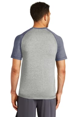 A grey and navy raglan t-shirt with short sleeves and a logo at the back, featuring a sporty design.