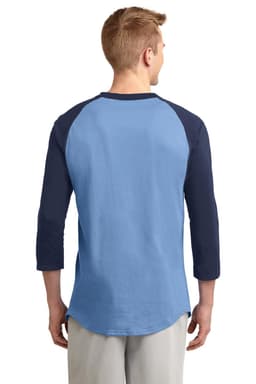 A man wearing a blue and navy Sport-Tek Colourblock Raglan Jersey, viewed from the back. The shirt has a casual fit and three-quarter sleeves.