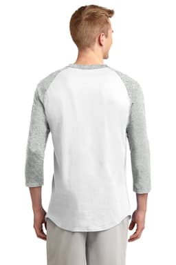 A man in a grey and white Sport-Tek Colorblock Raglan Jersey, viewed from the back. The shirt has three-quarter sleeves and a curved hem.