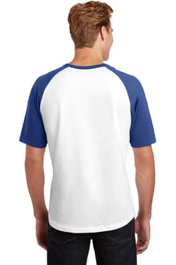 A man is wearing a white and blue Sport-Tek short sleeve colourblock raglan jersey from the back. It has a logo.