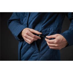 A women's quilted puffer jacket in blue, featuring a zip pocket and adjustable drawstring.