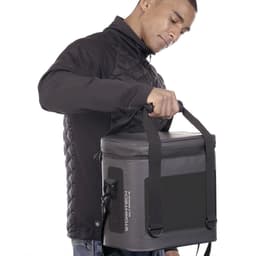 A cooler bag in grey is being held by a person wearing a black jacket, featuring a logo on the side.