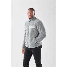 A grey men's Bergen Sherpa fleece jacket with a chest pocket and a logo, worn by a male model.