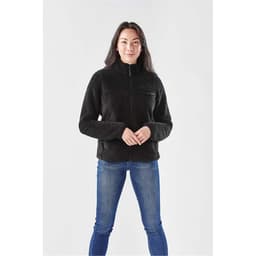 A black women's Bergen Sherpa fleece jacket with a zippered front and a small chest pocket, worn with blue jeans.