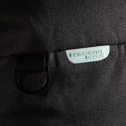 A black duffle bag featuring a light green logo tag and a metal loop attachment.