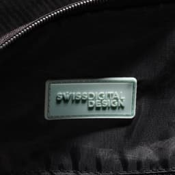 A close-up of the interior of a black duffle bag featuring a branded logo tag.