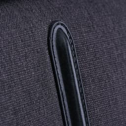 A close-up of a dark grey fabric with a black leather accent, part of the Swissdigital Arosa Duffle Bag.