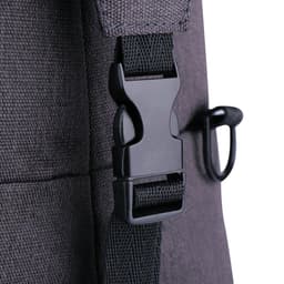 A close-up of a dark grey duffle bag featuring a black plastic buckle and strap.