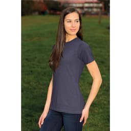 A woman wearing a short-sleeve, navy blue t-shirt in an outdoor setting, featuring a fitted design.