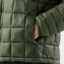 A puffer jacket in a dark green colour featuring a zip closure and a side pocket with a branded logo.