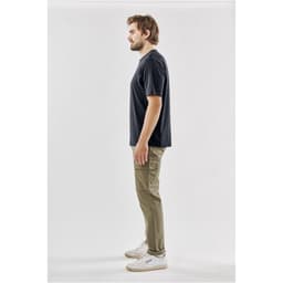 A black men's t-shirt displayed from the side, paired with khaki pants and white sneakers. The shirt features a logo.
