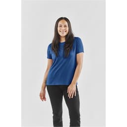 A blue women's t-shirt with a relaxed fit, modelled by a woman standing against a plain background.