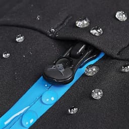 A close-up of a black softshell jacket featuring blue zip detailing and water droplets on the fabric.
