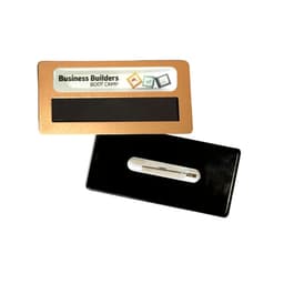 A gold and black staff badge featuring a magnetic backing and a plastic clip for attachment.