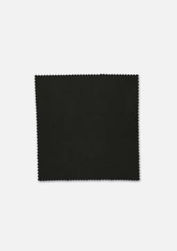 A square piece of black fabric with a textured edge, featuring a dark and smooth surface.