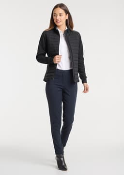 A women's tailor jacket in black, paired with a white shirt and navy trousers, featuring a sleek, contemporary design.
