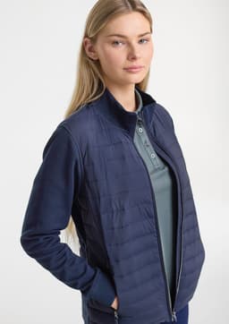 A women's tailor jacket in navy, featuring a zip front and a blend of quilted and smooth fabric.