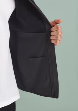 A black vest featuring a zip front and an interior pocket, showcasing a modern design and sleek style.