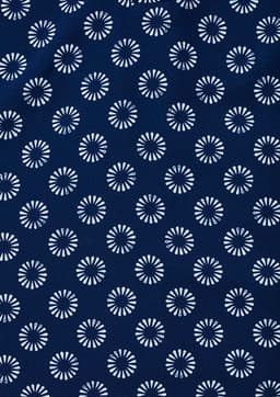 A navy tunic featuring a daisy print pattern in white. Includes a logo.