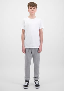 A pair of grey track pants with ribbed cuffs, displayed on a model wearing a white t-shirt and black shoes.