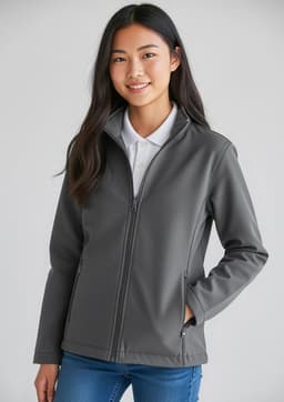 A grey Kids Apex Jacket featuring a front zip and a stand-up collar, modelled by a smiling young person.