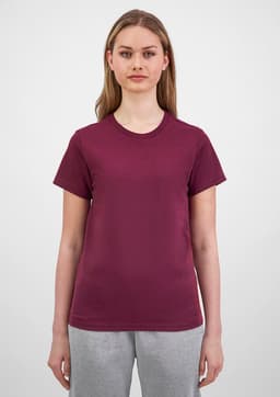 A woman wearing a maroon short sleeve tee, featuring a simple design and a round neckline.