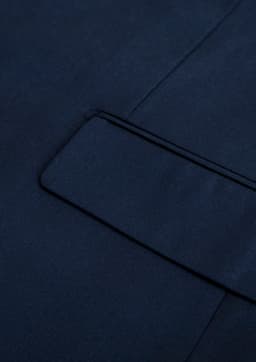 A navy blue men's jacket with a smooth texture and a detailed lapel. Features a branding logo.