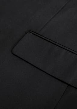 A black jacket featuring a sleek design with a subtle pocket detail and smooth fabric finish.