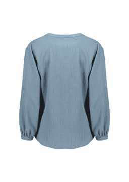 A women's long sleeve blouse in light blue, featuring a ruché design and a relaxed fit. It has a logo on the back.