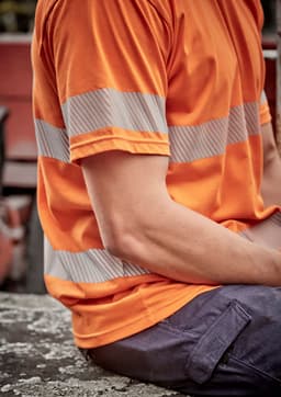 A men's short-sleeve hi-vis orange cotton tee with segmented reflective tape on the sleeves, featuring a relaxed fit.