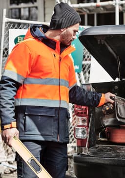 A unisex softshell jacket featuring high visibility orange and navy, with reflective stripes and a logo.